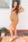 woman wearing a mustard floral maternity dress with ruffle hem and puff sleeves, showcasing her baby bump