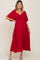 woman wearing a red maternity maxi dress with a tie front detail and short flutter sleeves, showcasing a visible baby bump