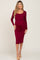 woman wearing a burgundy long sleeve maternity dress with a tie waist and a visible baby bump