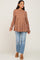 woman wearing a brown floral maternity top with a flowing silhouette and bell sleeves paired with distressed light blue jeans