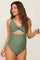 woman wearing a green maternity swimsuit with a cut-out design and gathered sides, model smiling and looking to the side