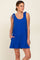 woman wearing a bright blue sleeveless romper with tie shoulder straps and side pockets