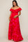 woman wearing a pink floral off-the-shoulder maternity maxi dress and holding her baby bump