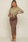 woman wearing a tied olive green button-up shirt and a brown ribbed maternity skirt with a slit, showcasing her baby bump