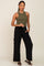 woman wearing olive green ribbed tank top and black wide leg cargo pants with sandals