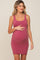 woman wearing a dusty rose ribbed maternity bodycon dress and holding her baby bump