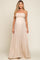 woman wearing a beige strapless maternity maxi dress with smocked bodice and flowing skirt, baby bump visible