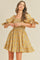 woman wearing a yellow plaid smocked dress with short puff sleeves and ruffle hem