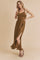 woman wearing a brown sleeveless maxi dress with a side slit and a fitted bodice