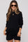 woman wearing a black maternity sweater and shorts set with a relaxed fit and sunglasses, showcasing her baby bump