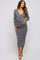 woman wearing a gray wrap maternity dress with a tie detail, showcasing her baby bump
