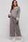woman wearing a grey maternity loungewear set with long sleeves and wide leg pants featuring white side stripes