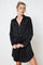 woman wearing a black long sleeve shirt dress with a tied waist detail and button-up front