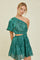 woman wearing a green one-shoulder dress with a cut-out waist and tiered skirt