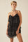 woman wearing a black sequined tiered mini dress with spaghetti straps and a statement choker necklace