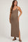 woman wearing a brown ribbed maxi maternity dress with side slits and a fitted silhouette, showing her baby bump