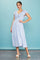 woman wearing a blue floral midi dress with ruffled sleeves and a v-neckline