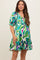 woman wearing a colorful patterned maternity dress with a baby bump and puff sleeves
