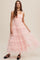 woman wearing a pink tiered tulle maxi dress with a smocked bodice and spaghetti straps