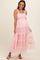 woman wearing a pink tiered tulle maternity dress with smocked bodice and baby bump visible