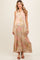 woman wearing a floral print sleeveless maternity maxi dress with a tiered skirt and a button-down collar