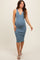 woman wearing a ribbed blue maternity dress with a v-neck and buttons, showcasing her baby bump