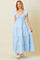 woman wearing a light blue tiered maxi dress with ruffled sleeves and a deep v-neckline