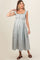 woman wearing a light blue floral maternity dress with a square neckline and buttons, showcasing her baby bump