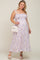 pregnant woman in purple floral smocked maternity maxi dress with white crossbody bag and sandals