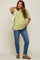 pregnant woman wearing a light green maternity t-shirt and blue jeans with a white tote bag