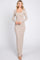 woman wearing a long beige ribbed maxi dress with a square neckline and long sleeves