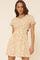 woman wearing a short floral print dress with puff sleeves and side cutouts