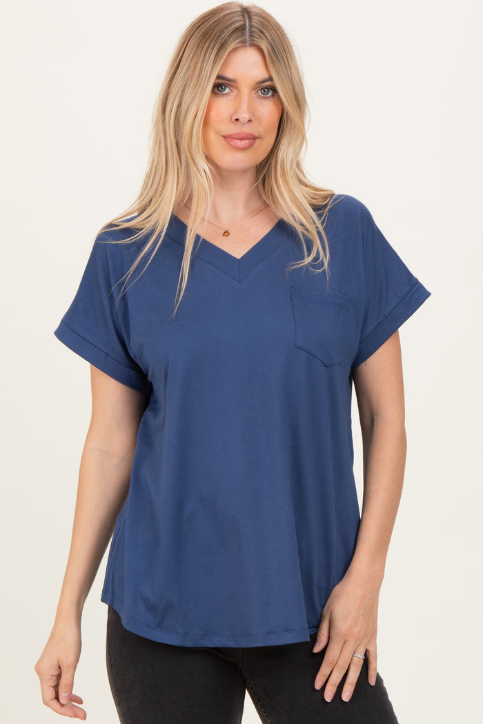 woman wearing a navy blue v-neck short sleeve top with a chest pocket