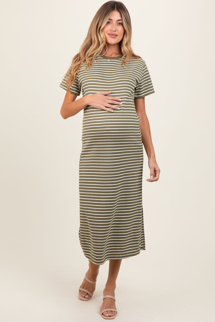 woman wearing a green and white striped maternity maxi dress, showcasing her baby bump