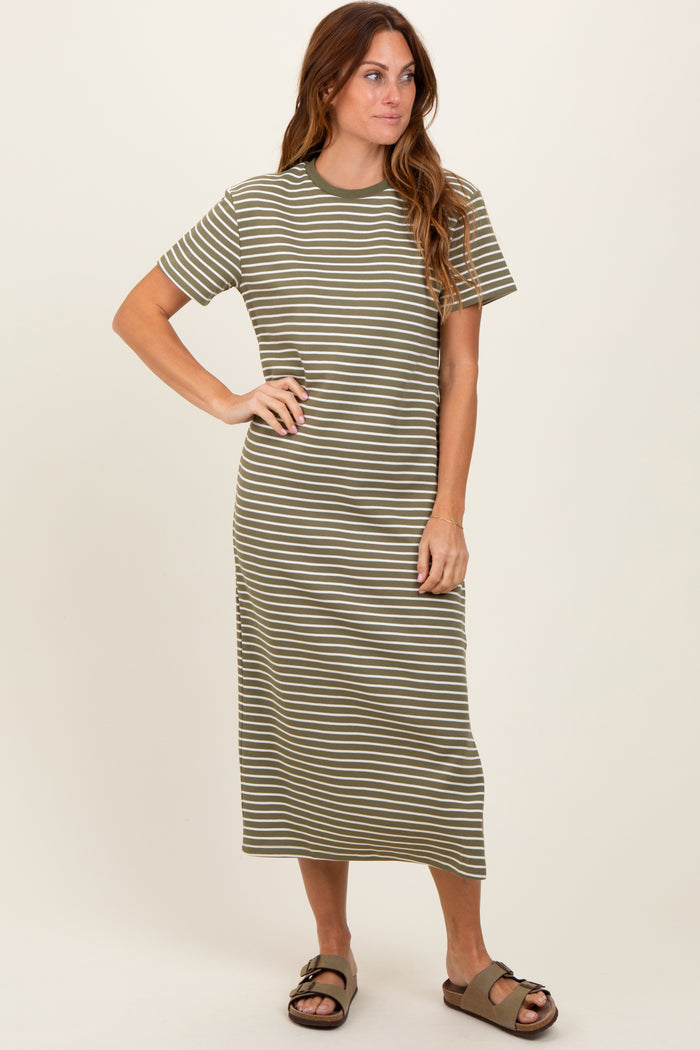 woman wearing a green and white striped short sleeve midi dress with a relaxed fit