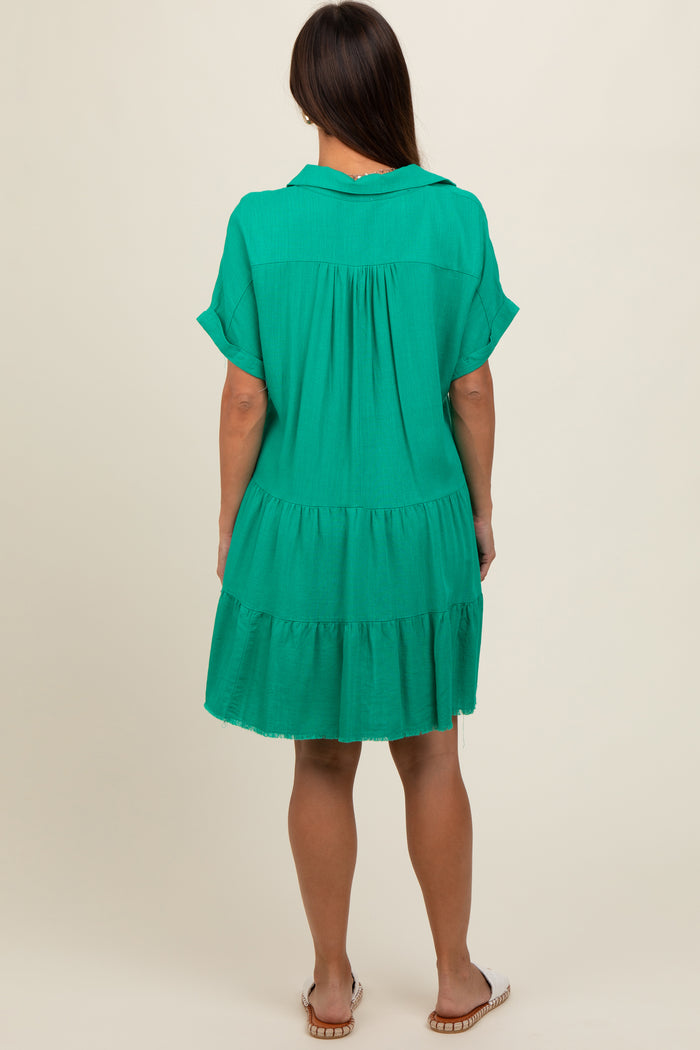 woman wearing a green maternity tiered dress with short sleeves, shown from the back