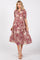 woman wearing a burgundy and cream floral midi dress with a collared neckline and puff sleeves