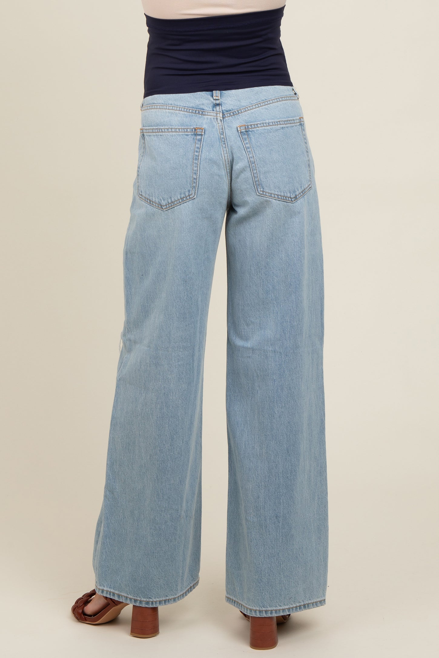 maternity wear light blue wide leg jeans with a stretchy waistband, model shown from the back