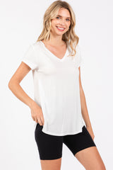 woman wearing a white short sleeve v-neck t-shirt paired with black bike shorts