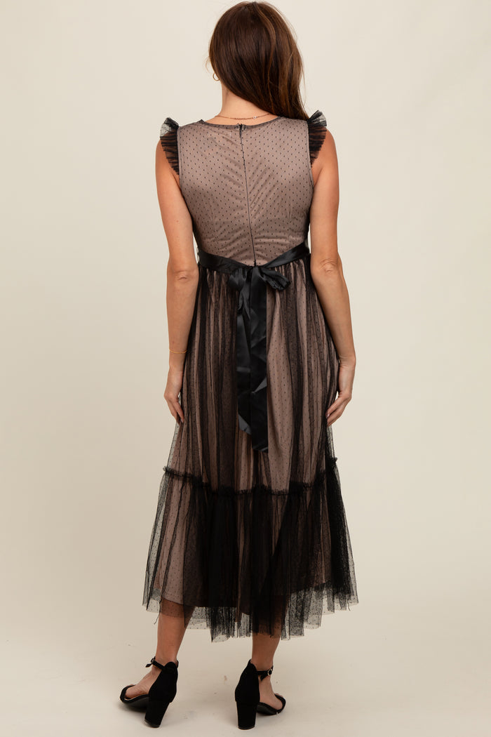 woman wearing a brown tulle midi dress with ruffle sleeves and a black satin tie at the waist, shown from the back
