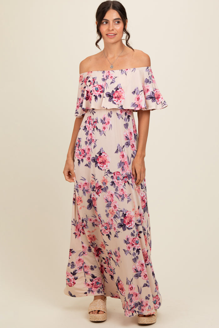 woman wearing a floral off-the-shoulder maxi dress with ruffle details and a flowing silhouette