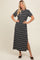 woman wearing a black and white striped maxi dress with short sleeves and side slits