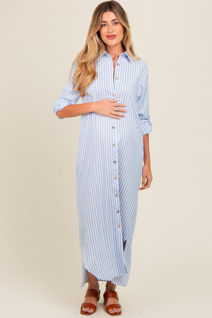 woman wearing a blue and white striped maternity maxi shirt dress, holding her baby bump with a casual smile