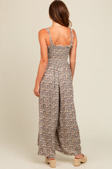 woman wearing a floral backless maxi dress with ruffled straps and a smocked bodice