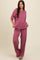 woman wearing a mauve relaxed fit short sleeve top and matching wide leg pants in a textured fabric