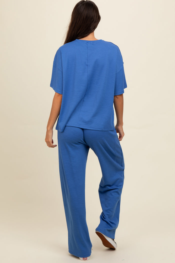 woman wearing a blue relaxed fit ribbed top and matching wide-leg pants, viewed from the back