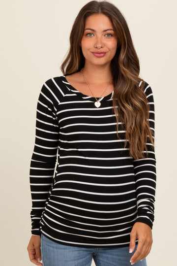 woman wearing a black and white striped maternity top with long sleeves and a scoop neck