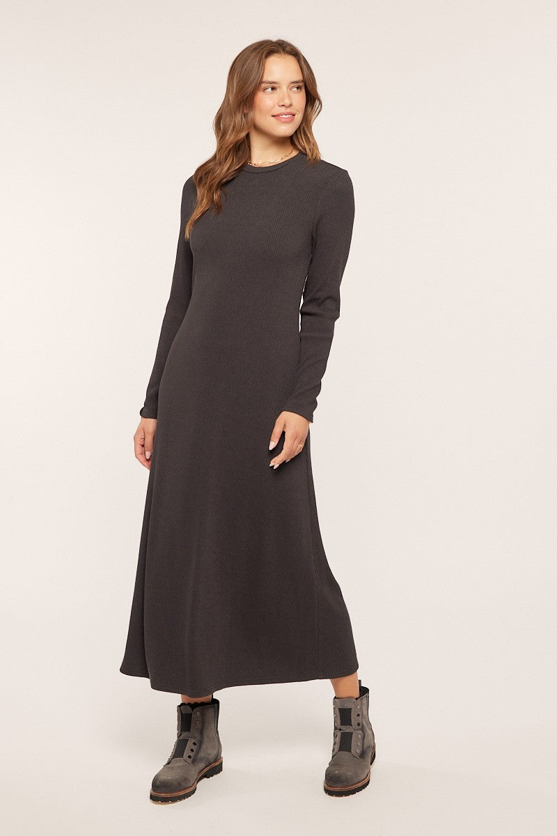 woman wearing a dark gray long sleeve maxi dress and black ankle boots
