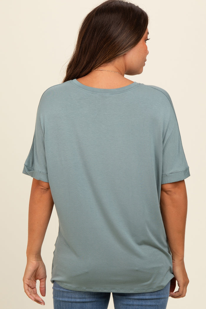 woman wearing a muted teal maternity top with short sleeves, seen from the back