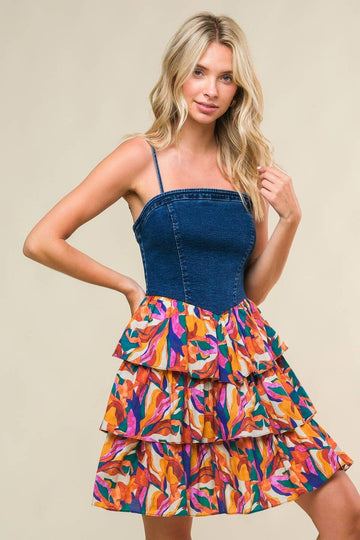 woman wearing a denim bodice dress with colorful tiered floral print skirt
